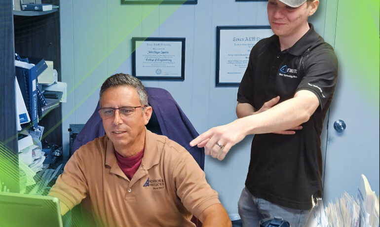Photo showing a computer technician helping a man at his computer.